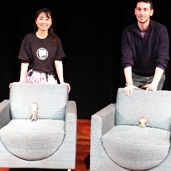 Two People standing in front of chairs